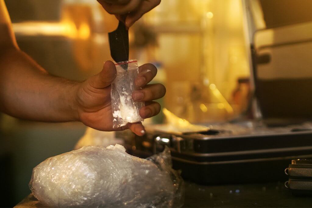 person packaging illegal drugs - drug smuggling concept