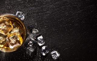 A glass of whiskey and spilt ice - alcohol detox in Atlanta
