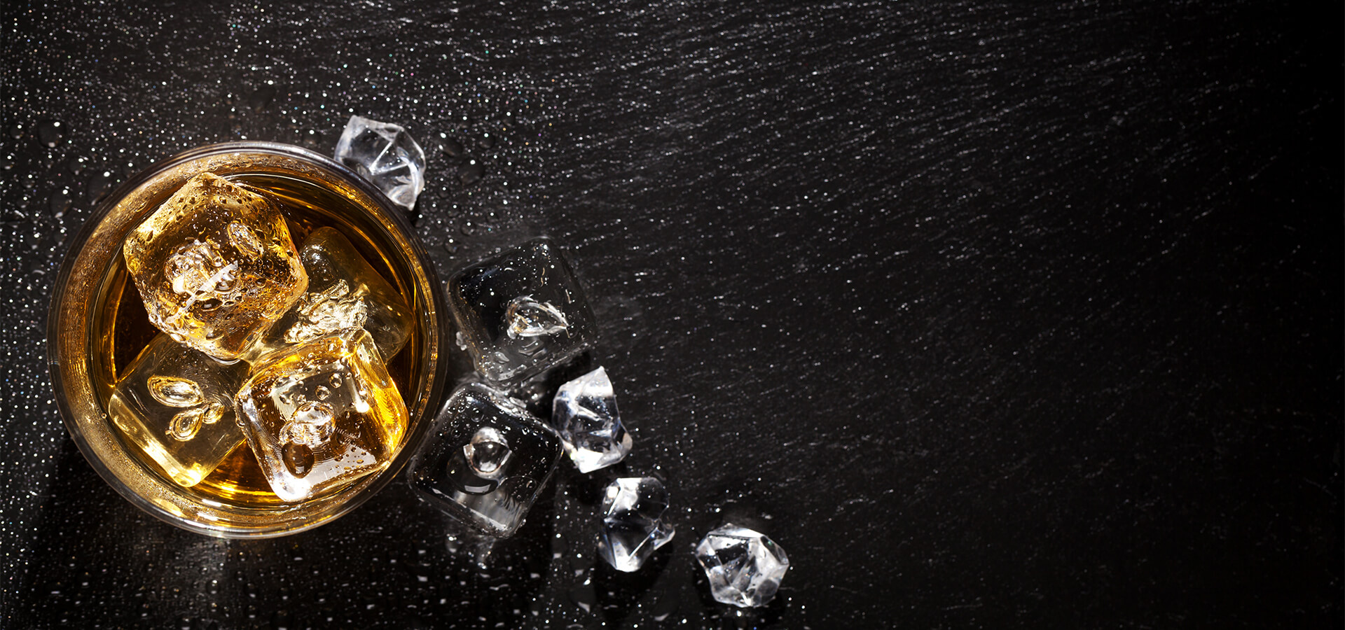 A glass of whiskey and spilt ice - alcohol detox in Atlanta