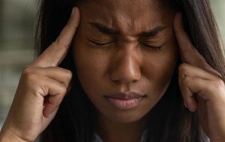women putting pressure on her temples