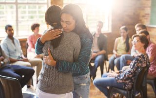 two people helping each other when staying sober feels hard