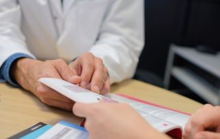 two people looking at a book about heroin overdose facts