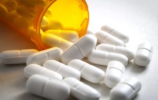 spilled pill bottle showing the risks of prescription painkillers