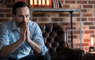 person seated thinking about negative thoughts and addiction recovery