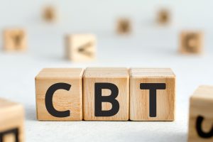 3 wooden blocks with the letters CBT - Benefits of cognitive-behavioral therapy