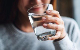 woman drinking water in medical detox - medically assisted detox in Atlanta GA