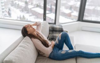 Woman on couch in pain detoxing alone