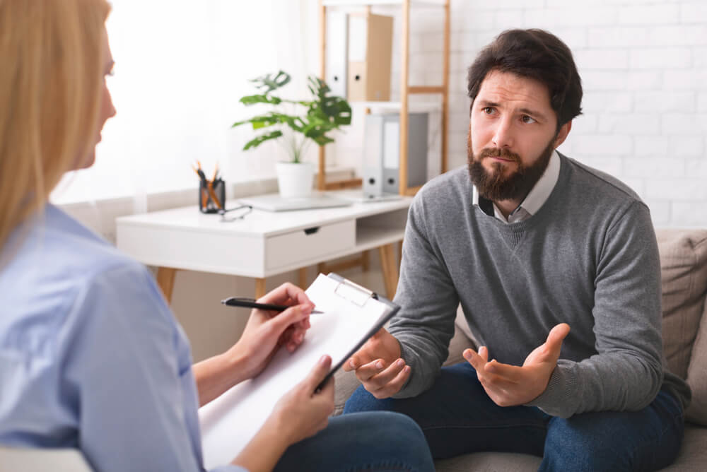 man receiving cognitive behavioral therapy - what does CBT help with concept