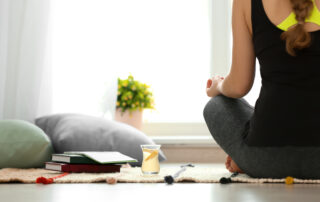 Woman meditating in her home - Safety of Detox at Home concept image