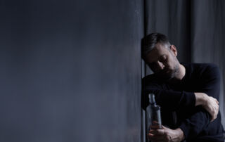 Man hungover and contemplating Alcohol Detox and Recovery