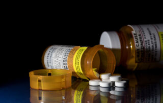 bottle of opioids - opioid prescription rate