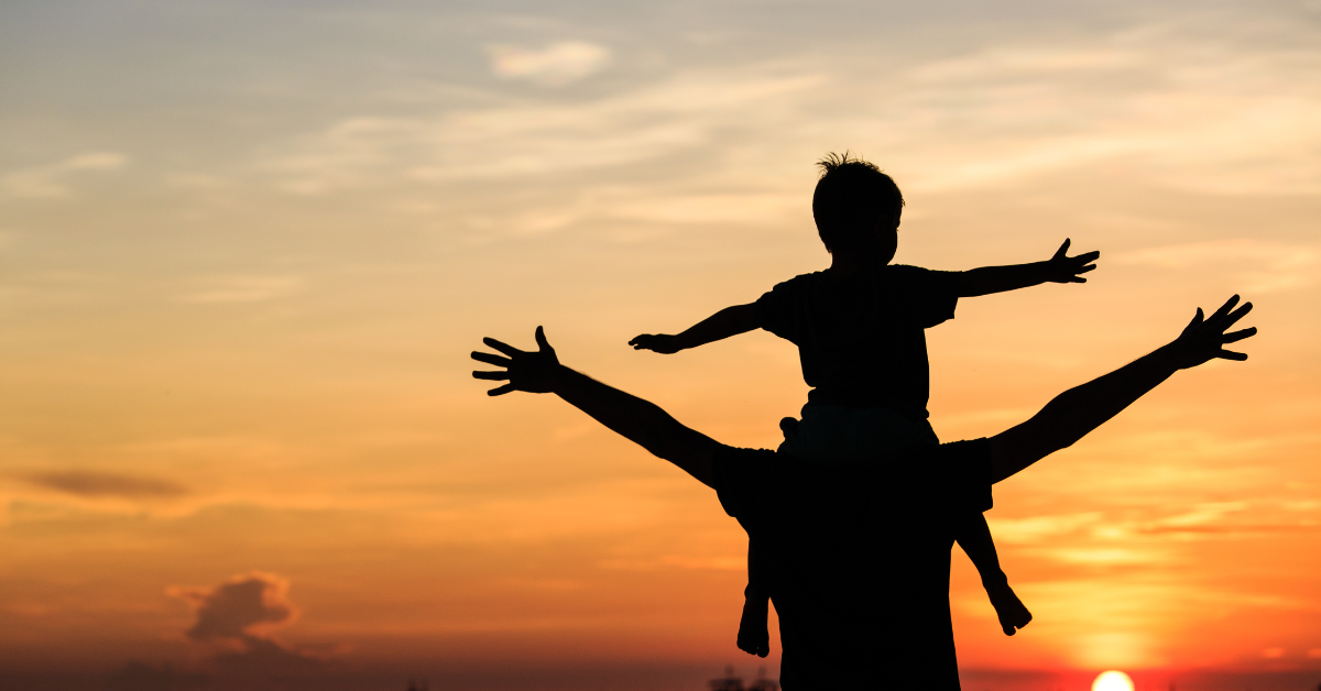 A son on his father's shoulders