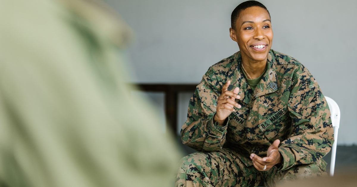 A servicewoman sits in uniform.