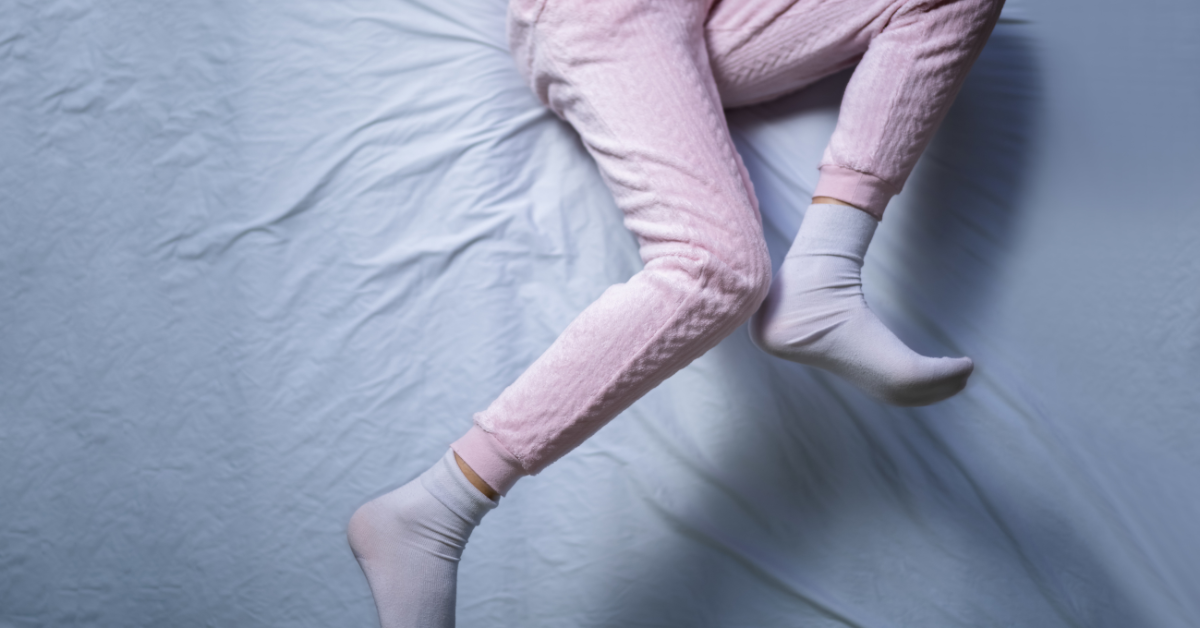 Legs kicking on a bed