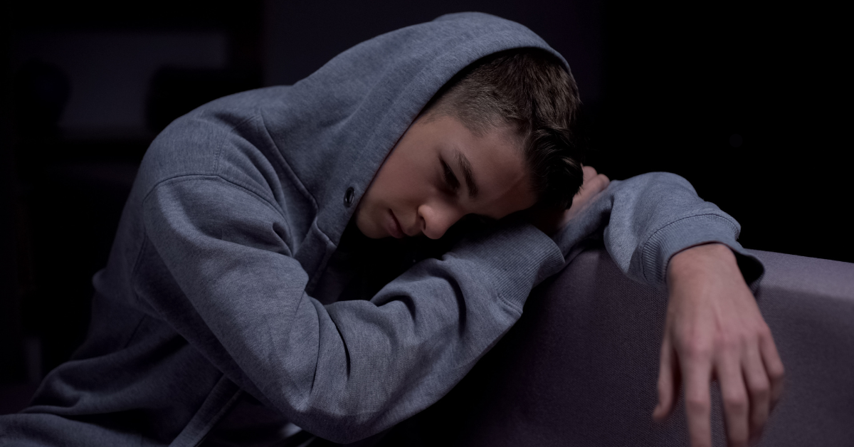 Person in a hoodie leans their head over.