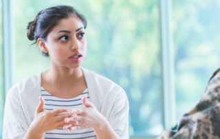 woman speaking to an active-duty service member
