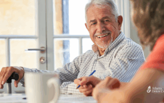 Smiling older man in conversation at a table, symbolizing clarity and connection while addressing concerns about benzodiazepine use and dementia risk.